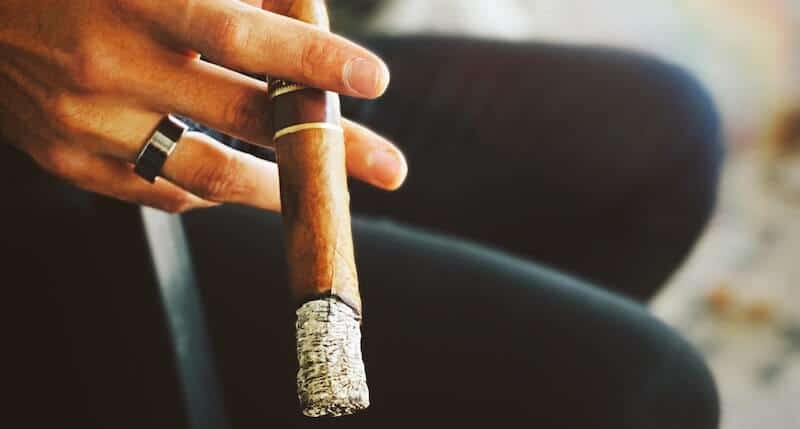 holding cigar